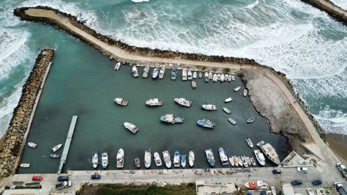Free Explore this captivating aerial view of a vibrant coastal harbor filled with boats. Stock Photo