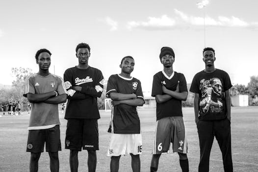A group of young men posing confidently on a soccer field in Los Angeles, California.