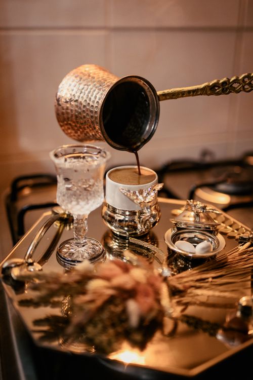 Free Experience the elegance of a traditional Turkish coffee service complete with ornate silverware. Stock Photo