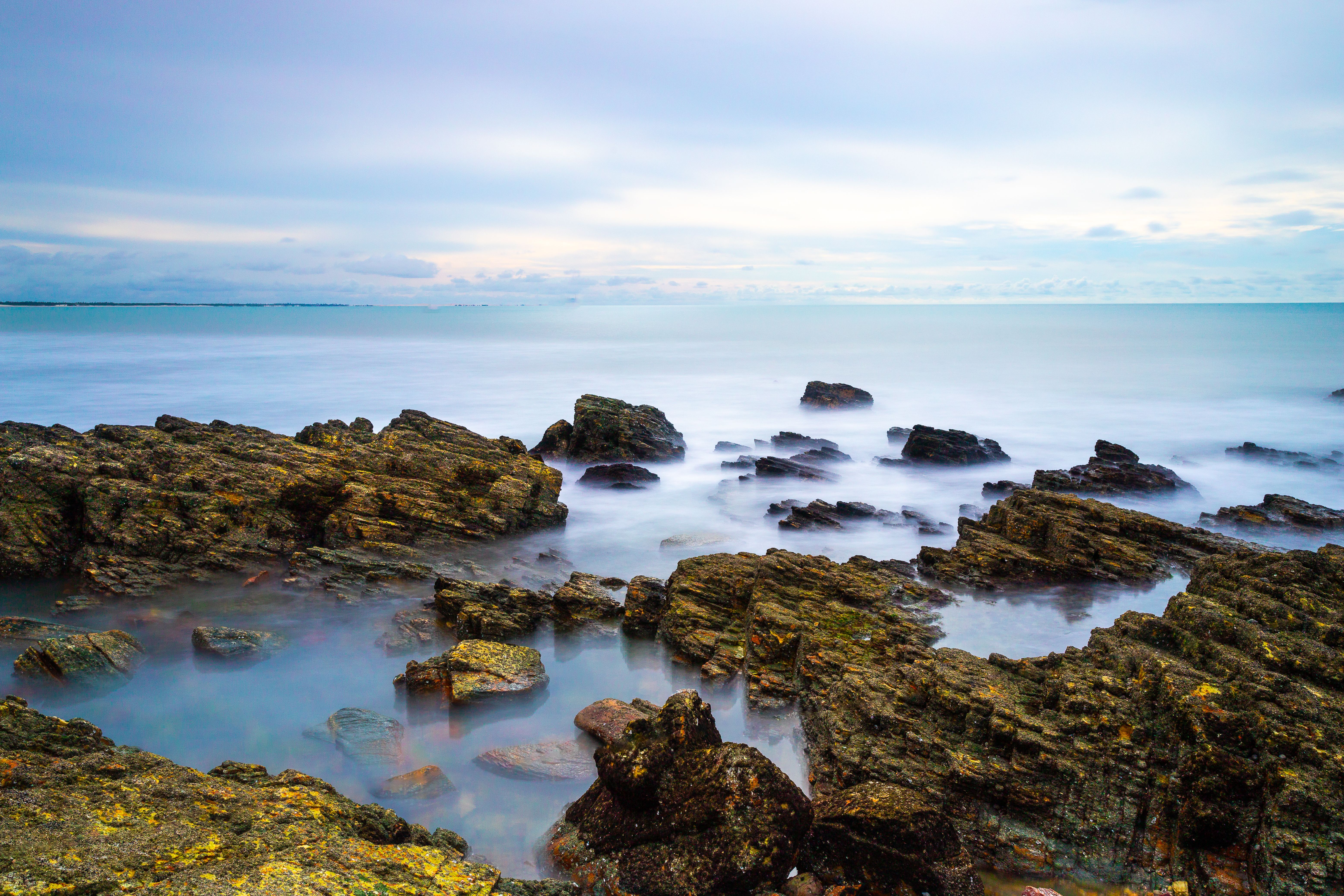Experience the tranquil beauty of Jericoacoara's rocky coastline with long exposure waves.