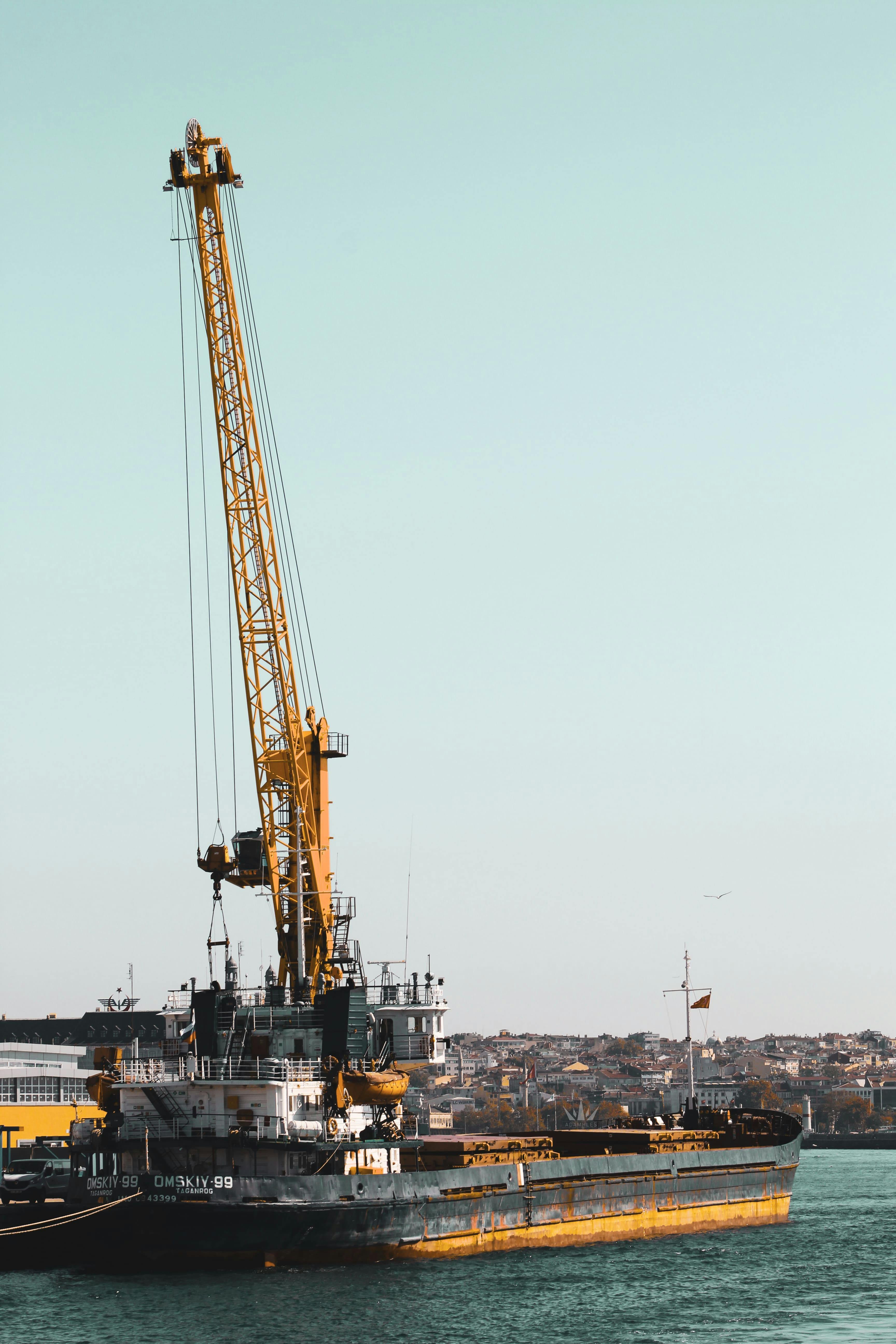 black and yellow crane on ship