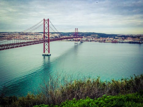 A stunning image of the iconic 25 de Abril Bridge spanning the Tagus River in Lisbon, Portugal.
