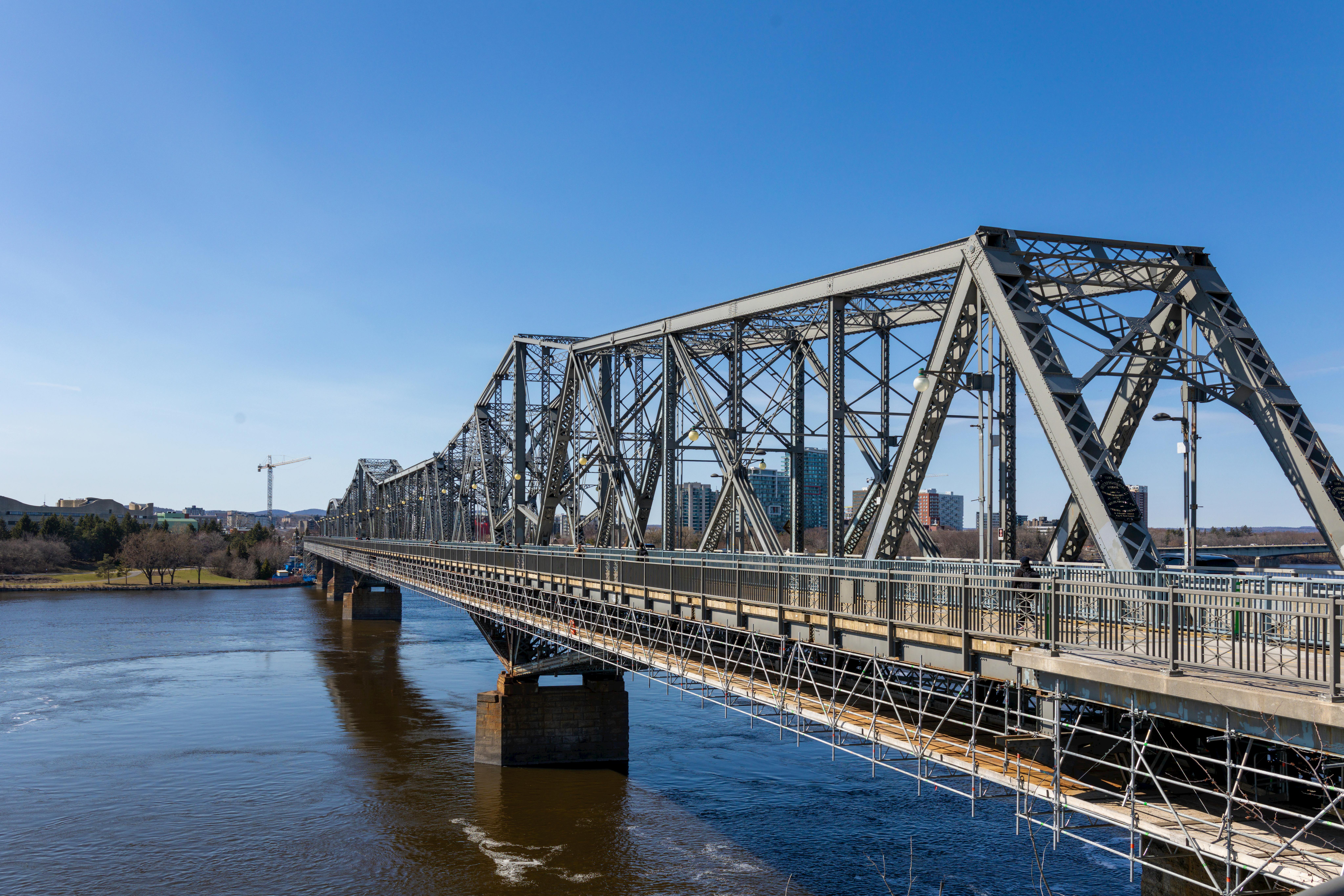 Scenic view of the historic Alexandra Bridge in Ottawa over the tranquil Ottawa River. - Ottawa