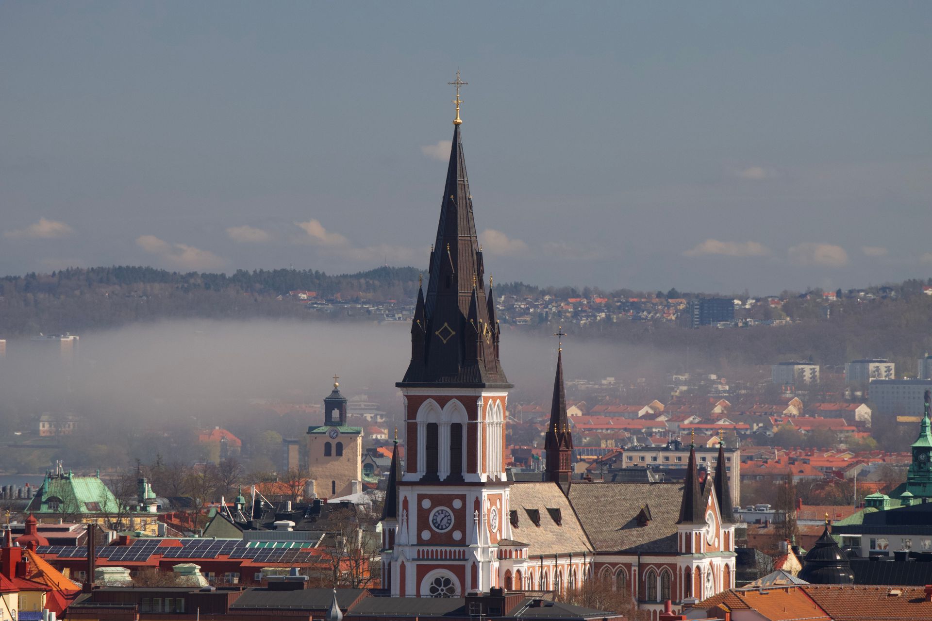 Captivating aerial view of Jönköping, Sweden, featuring a prominent church spire under a vast sky.