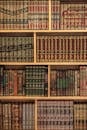 Beautifully Arranged Islamic Books on Wooden Shelves