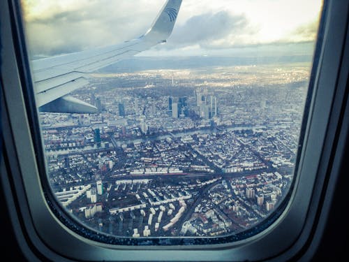 Airplane Windowpane Showing City Buildings