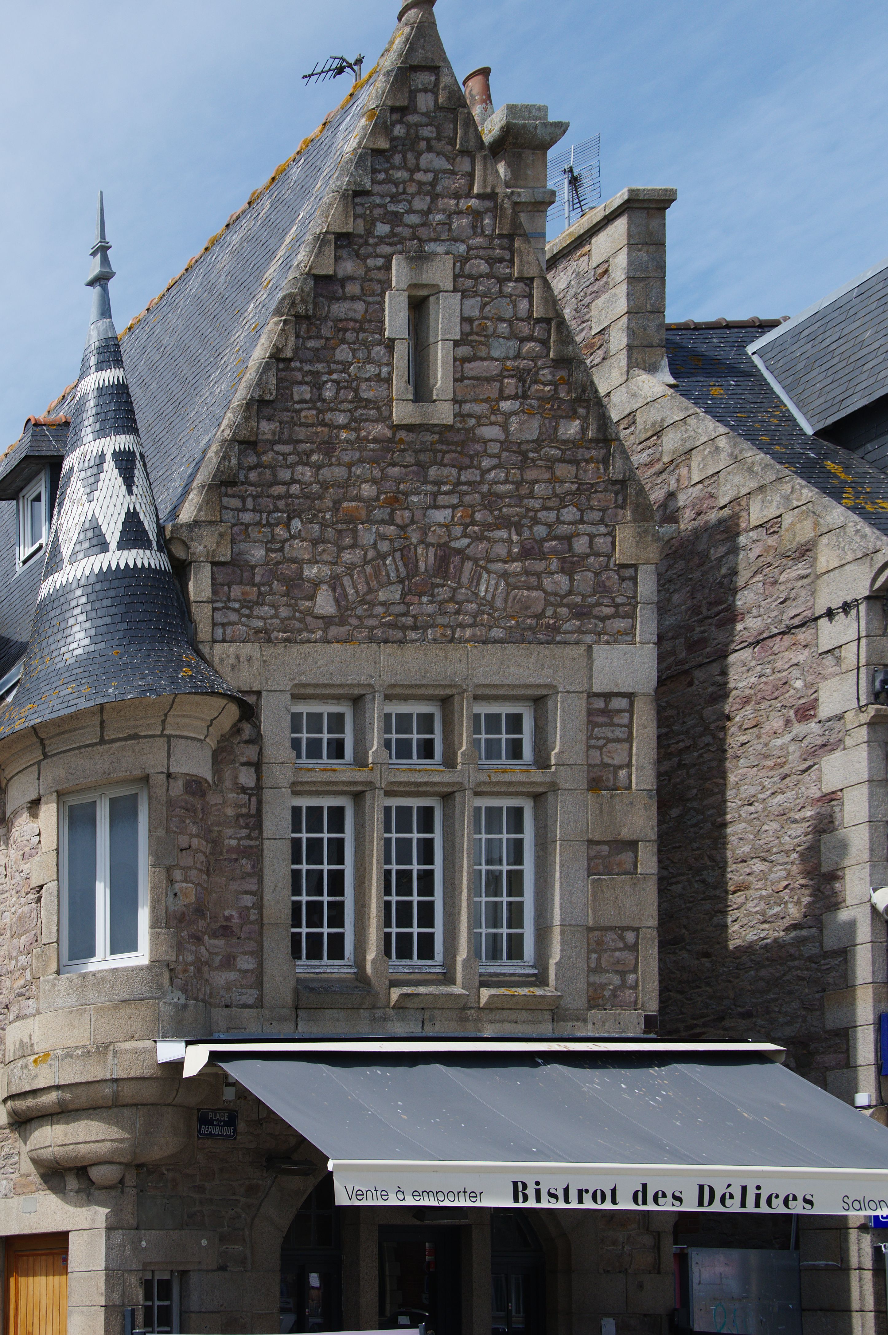 Historic stone building facade in a quaint Brittany village, perfect for travel and architecture lovers.