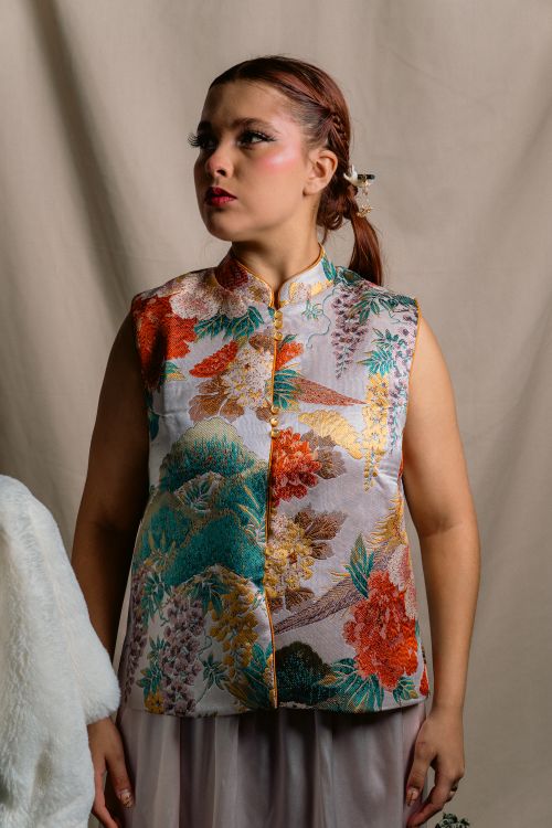 Free Woman wearing a colorful floral vest in a classic indoor setting, Leon, Mexico. Stock Photo