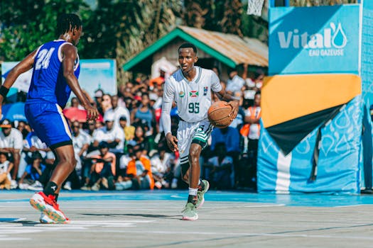 Outdoor basketball game captures dynamic play and vibrant crowds.