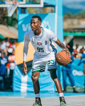 Dynamic image of a basketball player dribbling outdoors.