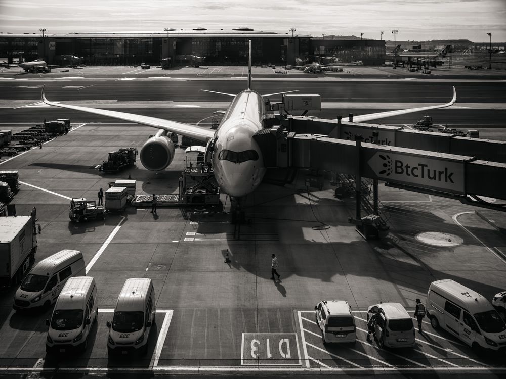 Plane In Gate Airplane at Gate with Jetway and Vehicles · Free Stock Photo