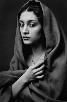 Expressive black and white portrait capturing a woman in traditional attire.