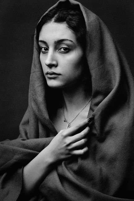 Expressive black and white portrait capturing a woman in traditional attire.