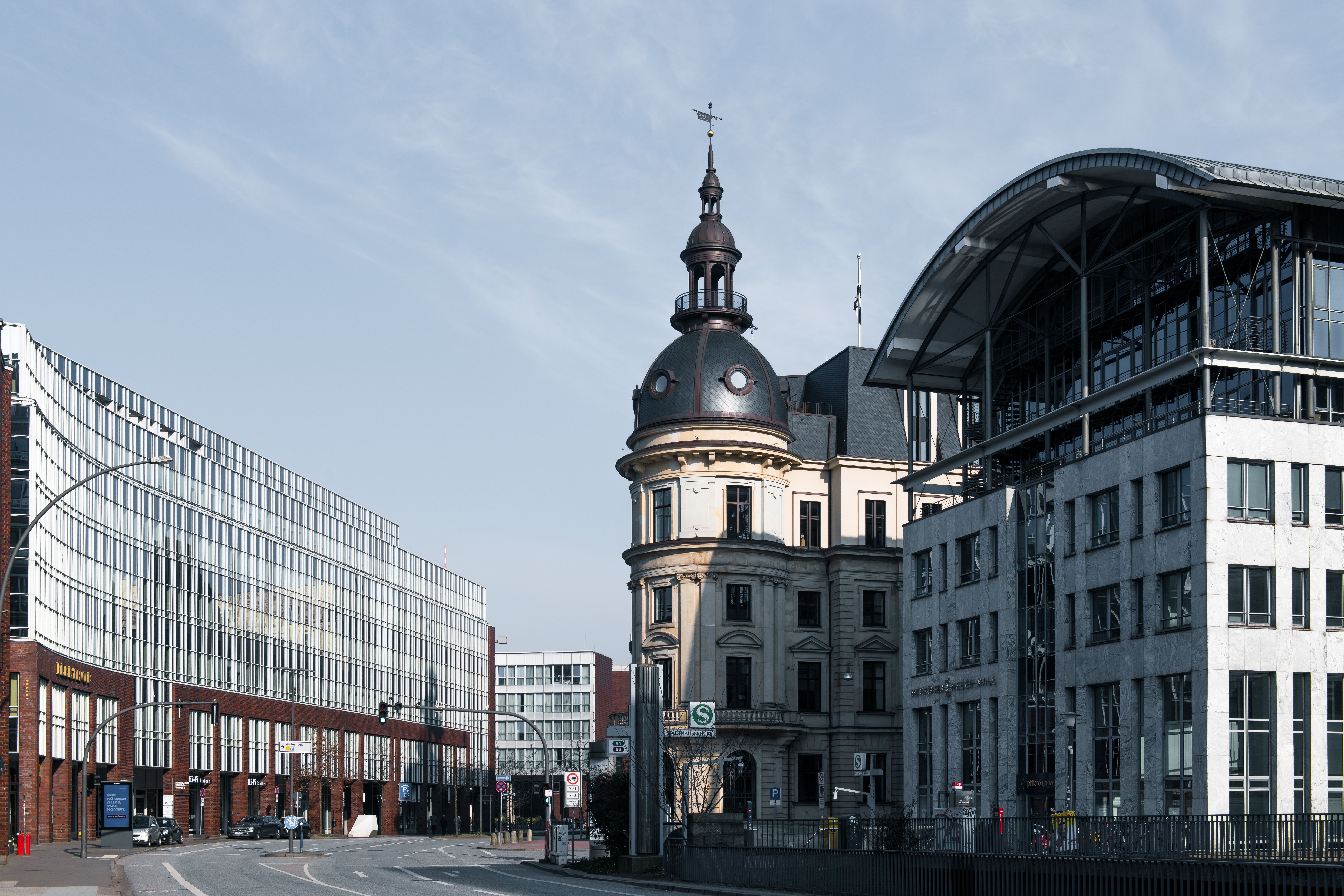 Explore Hamburg's cityscape with a blend of historic and modern architecture under a bright sky.