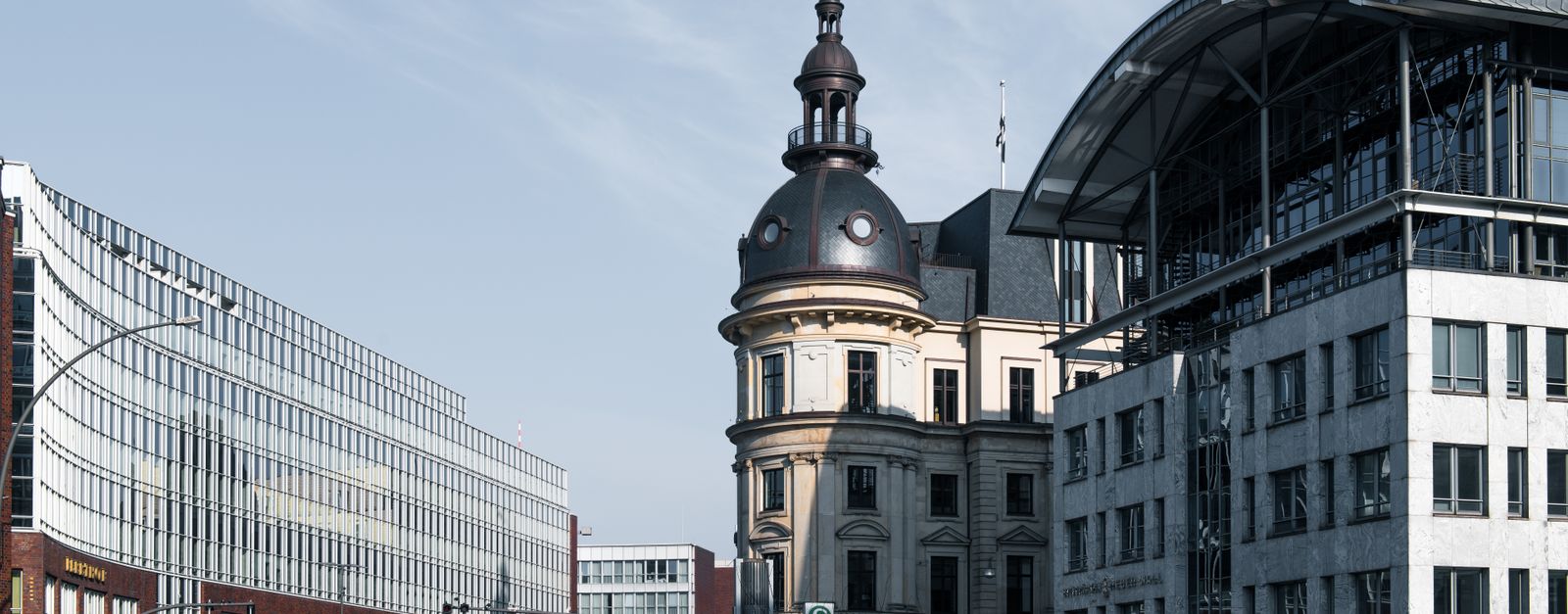 Explore Hamburg's cityscape with a blend of historic and modern architecture under a bright sky.