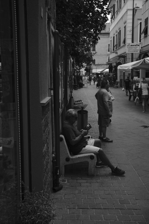 Free Black and white photo of a street in Italy with people and architecture. Stock Photo