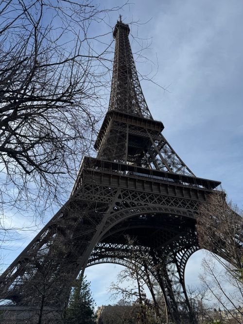 Free Captivating view of the Eiffel Tower against a clear sky, showcasing its architectural beauty. Stock Photo