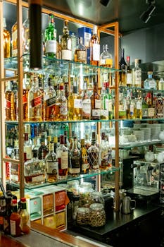 Modern bar interior showcasing an extensive selection of spirits in a stylish and inviting atmosphere.