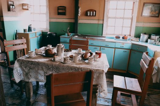A charming vintage kitchen in Malta with a table set for breakfast, showcasing a rustic and cozy atmosphere.
