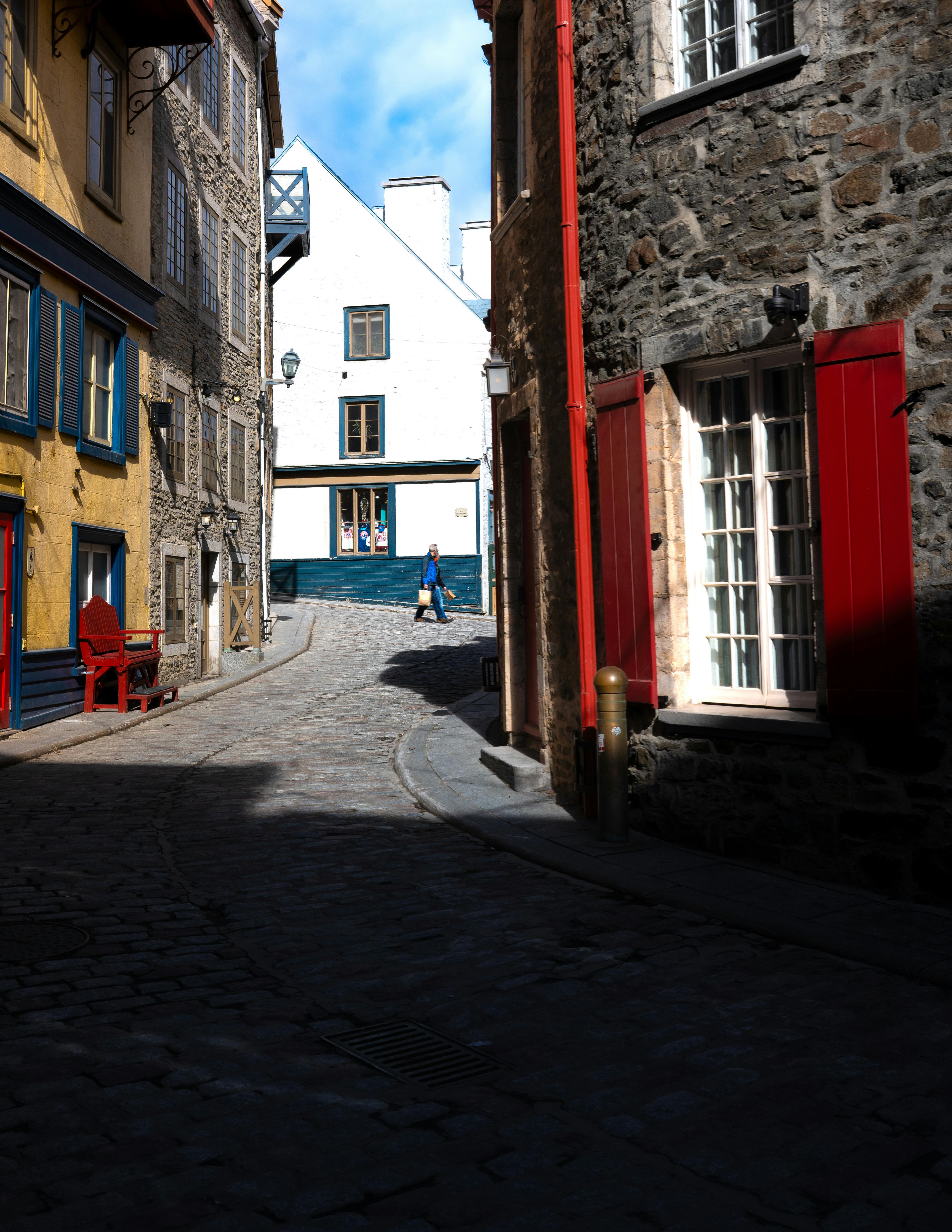 Peaceful narrow alley with vibrant historic architecture.