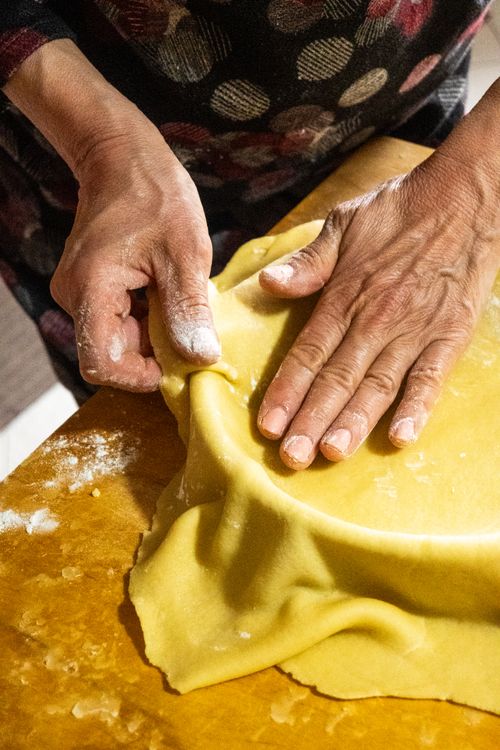 Free Close-up of hands shaping fresh pastry dough with a rustic feel, ideal for baking enthusiasts. Stock Photo