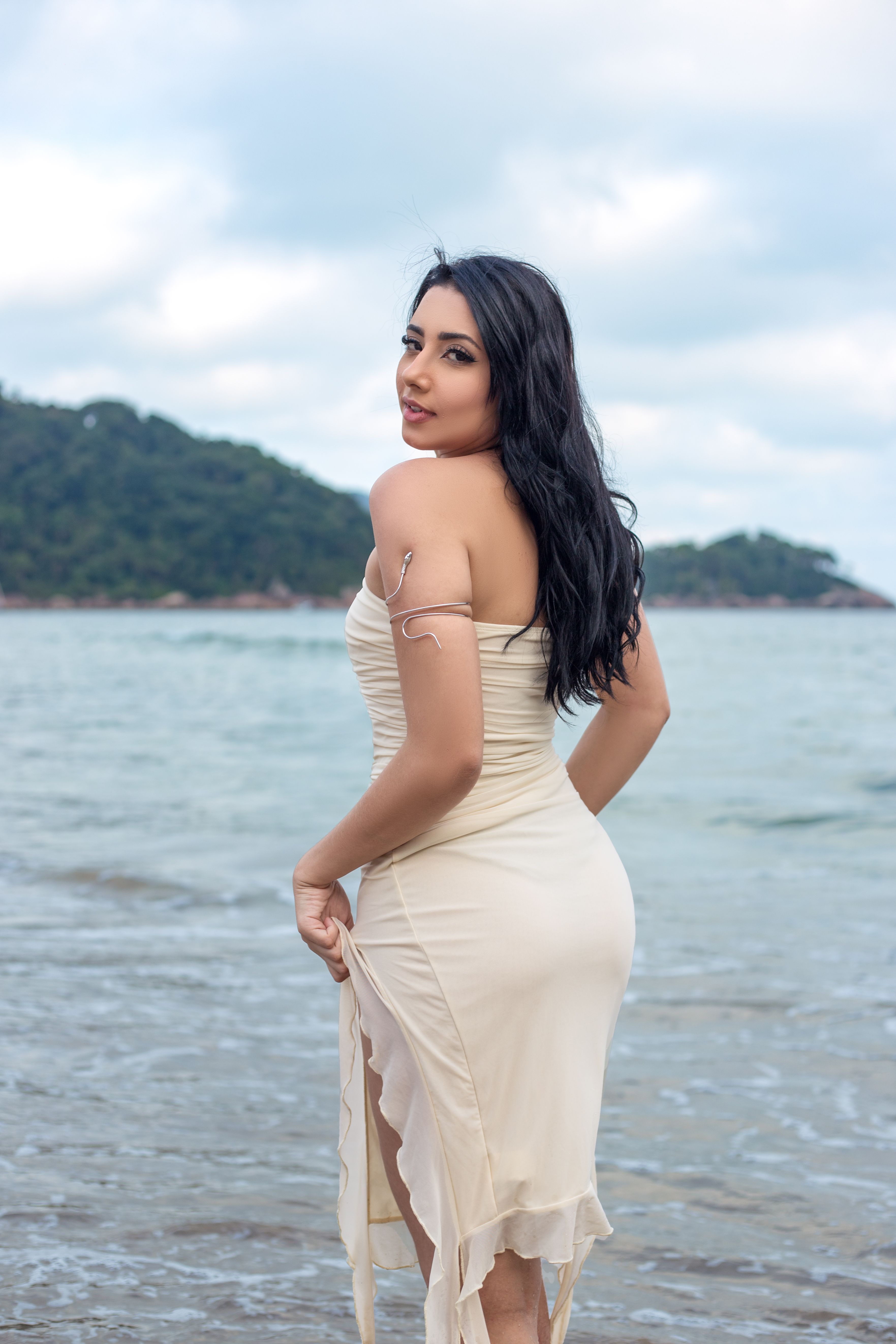 Elegant Woman in Beige Dress at the Beach  Free Stock Photo