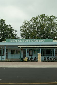Front view of Bến Xe Buyt Cần Giờ in Vietnam, captured in daylight with a focus on structure and greenery.