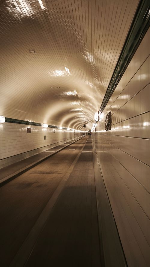 Free Long view inside the illuminated Elbe Tunnel in Hamburg, Germany. Stock Photo