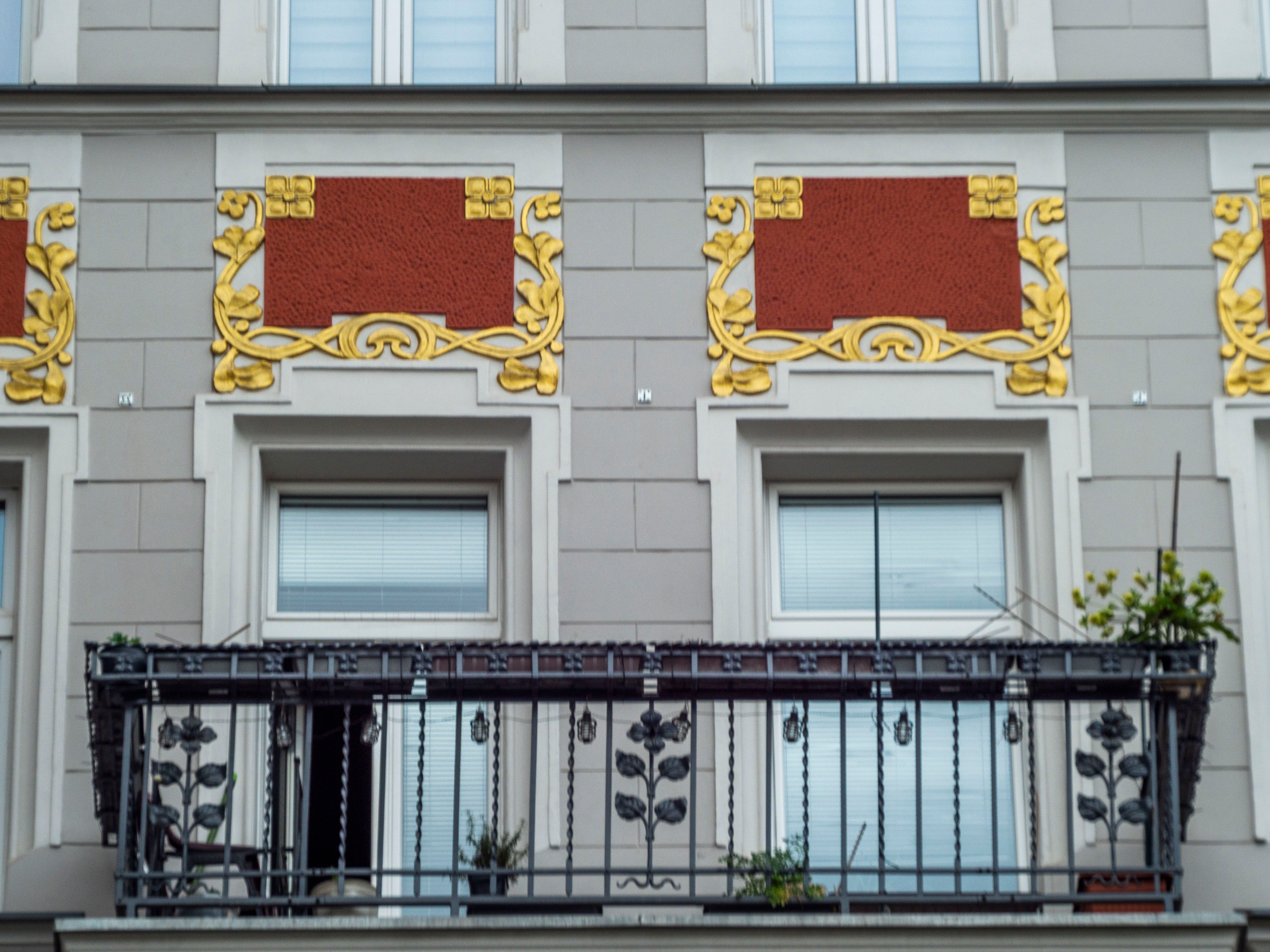 Close-up of an ornate Art Nouveau building facade with intricate balcony and decorative details.. close, ornate, nouveau