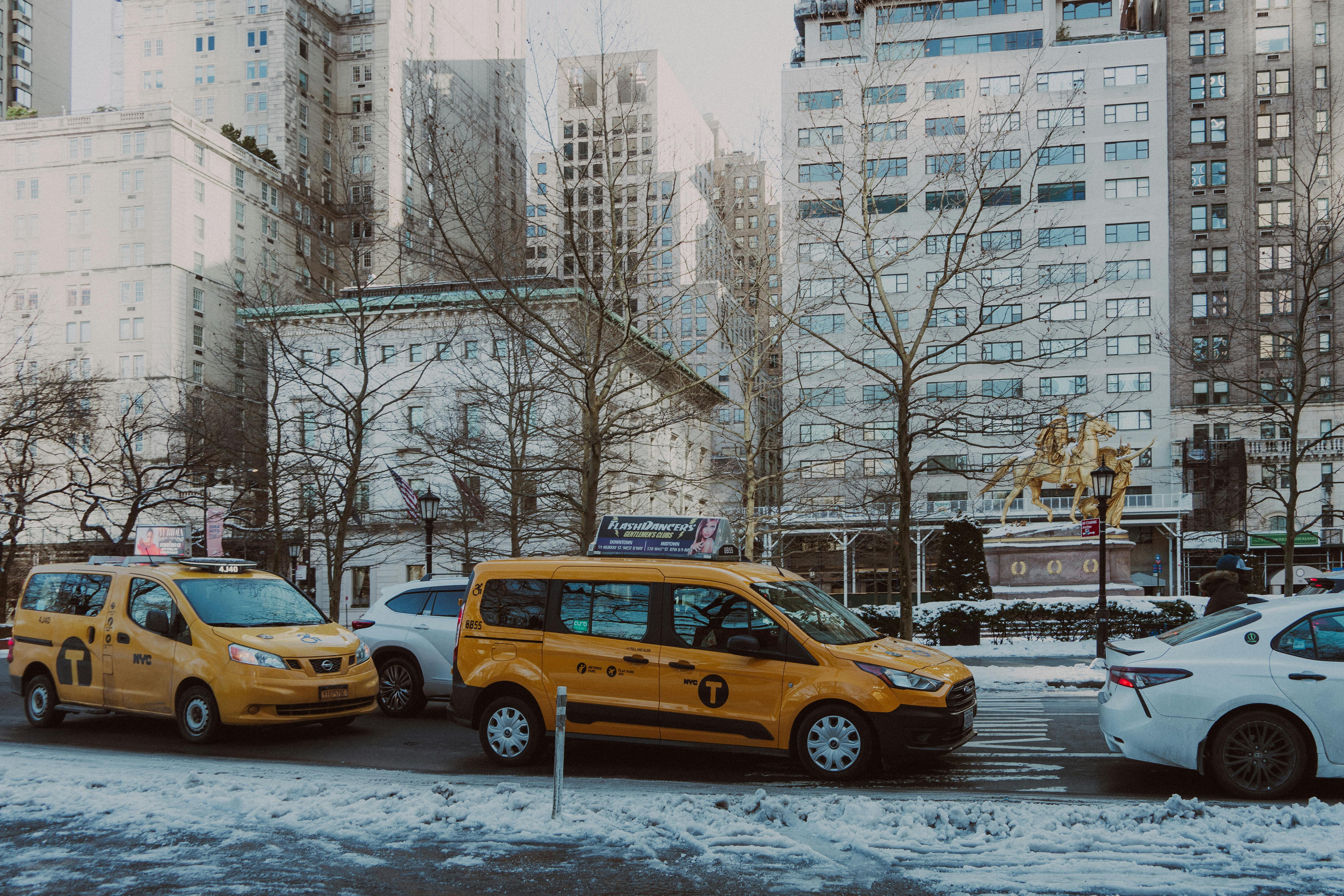 body treatments Floral Park NY - Yellow taxis on a snowy street in New York City, surrounded by tall buildings.