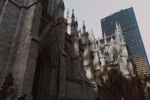 Free Gothic-style St. Patrick's Cathedral beside a modern skyscraper in New York City. Stock Photo