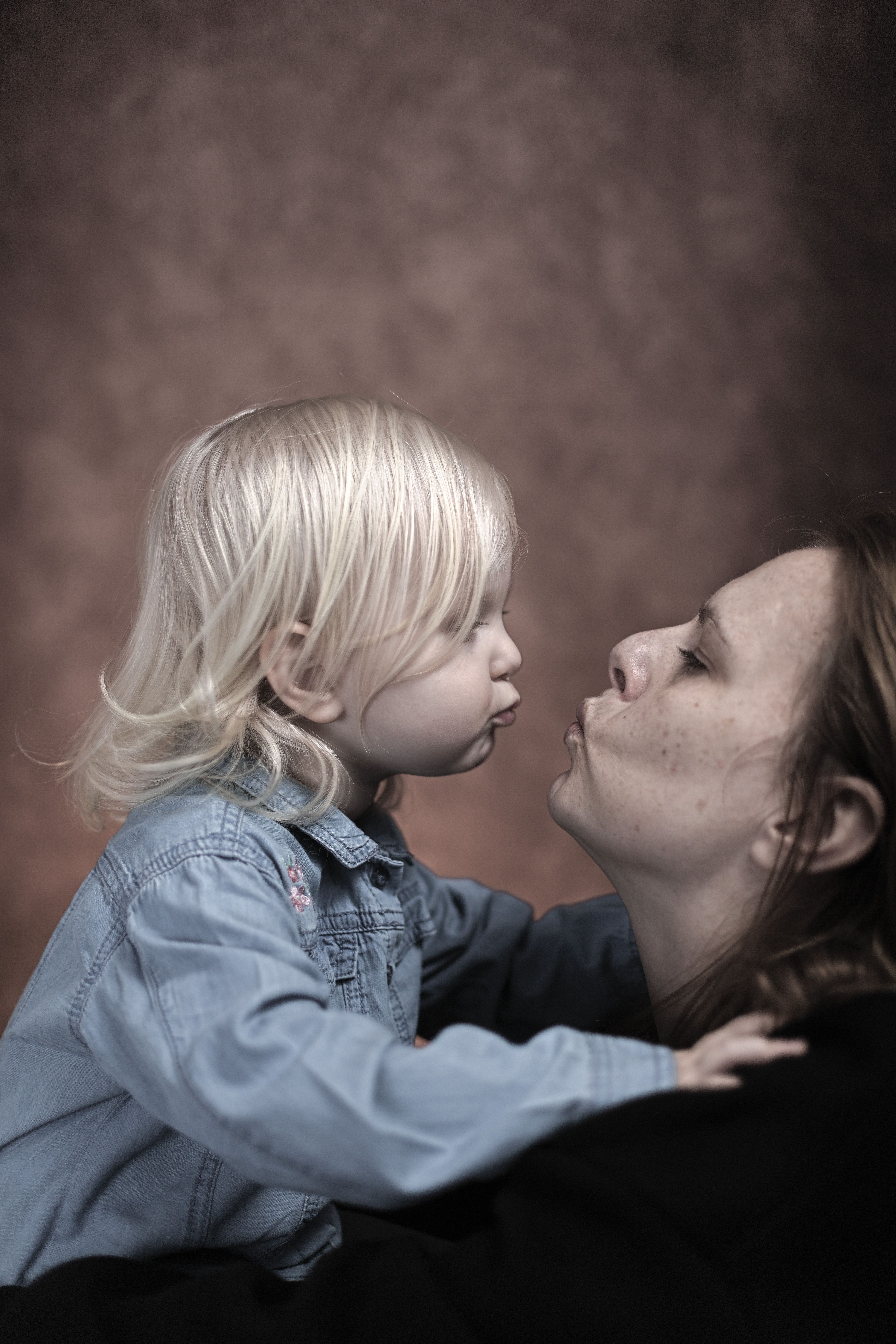 Loving Mother and Child Portrait in Studio Setting · Free Stock Photo