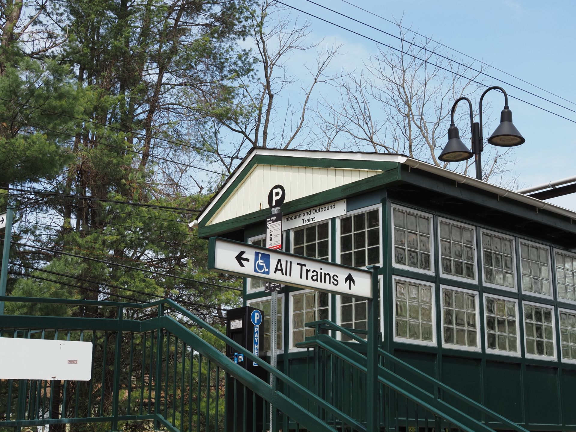 A serene view of a train station entrance in New Britain, showcasing rail signage and architectural details.