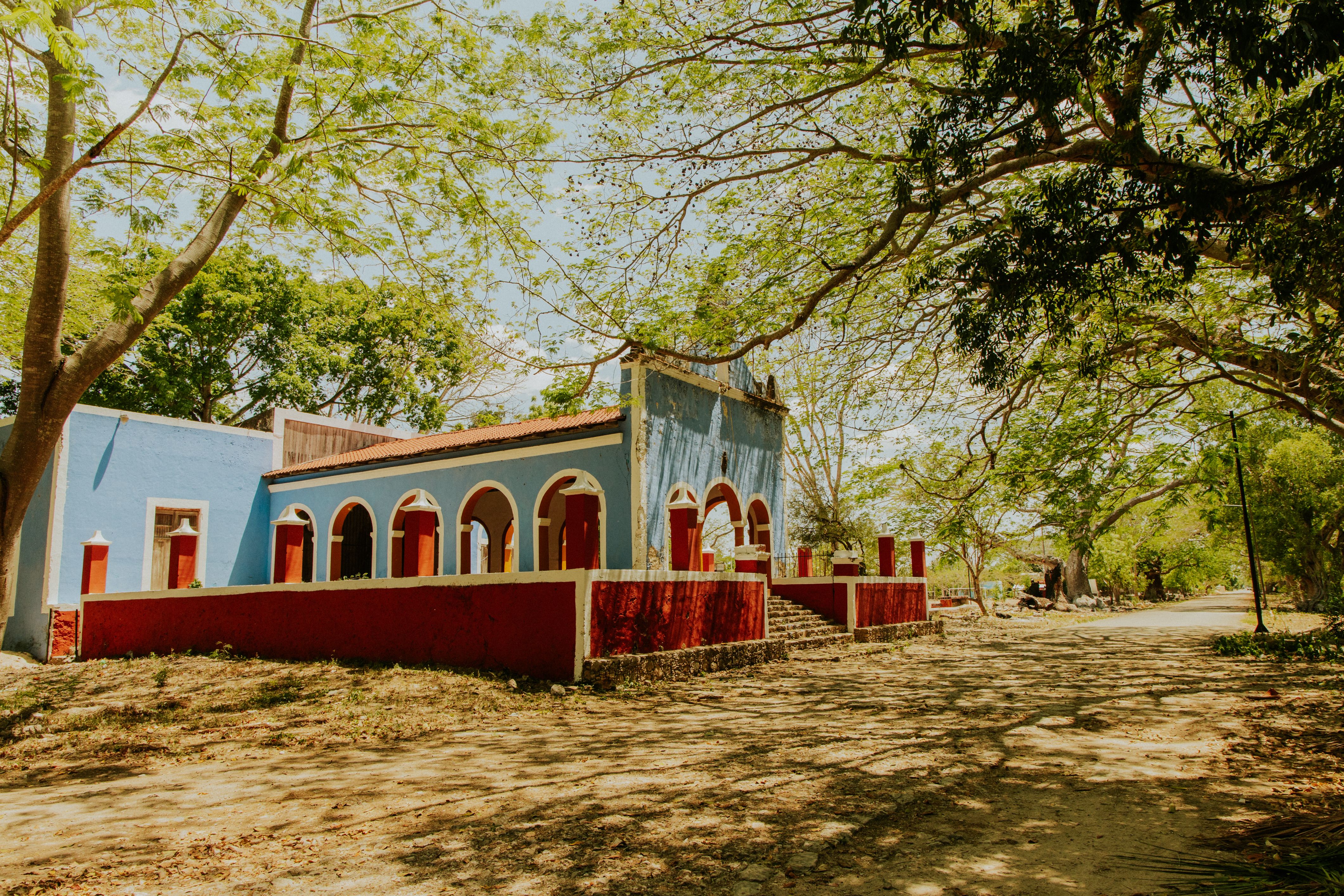 Colorful Colonial Architecture in Lush Landscape · Free Stock Photo