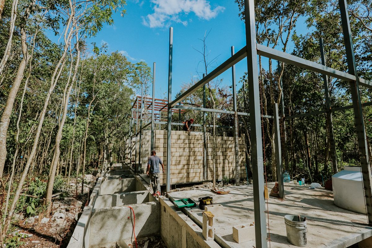 Villa under construction in tropical surroundings