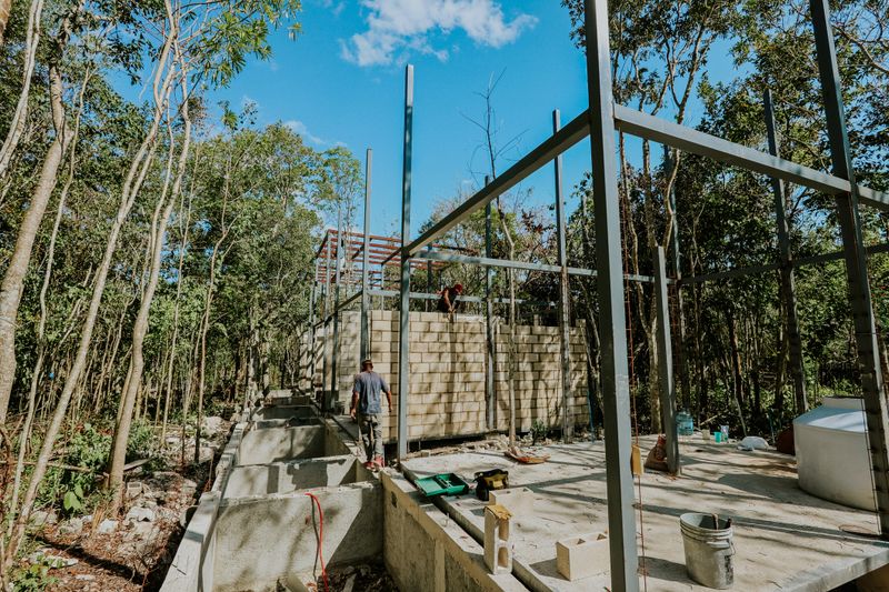 Villa under construction in tropical surroundings