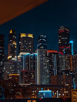 A stunning nighttime cityscape featuring brightly lit skyscrapers against a dark sky.