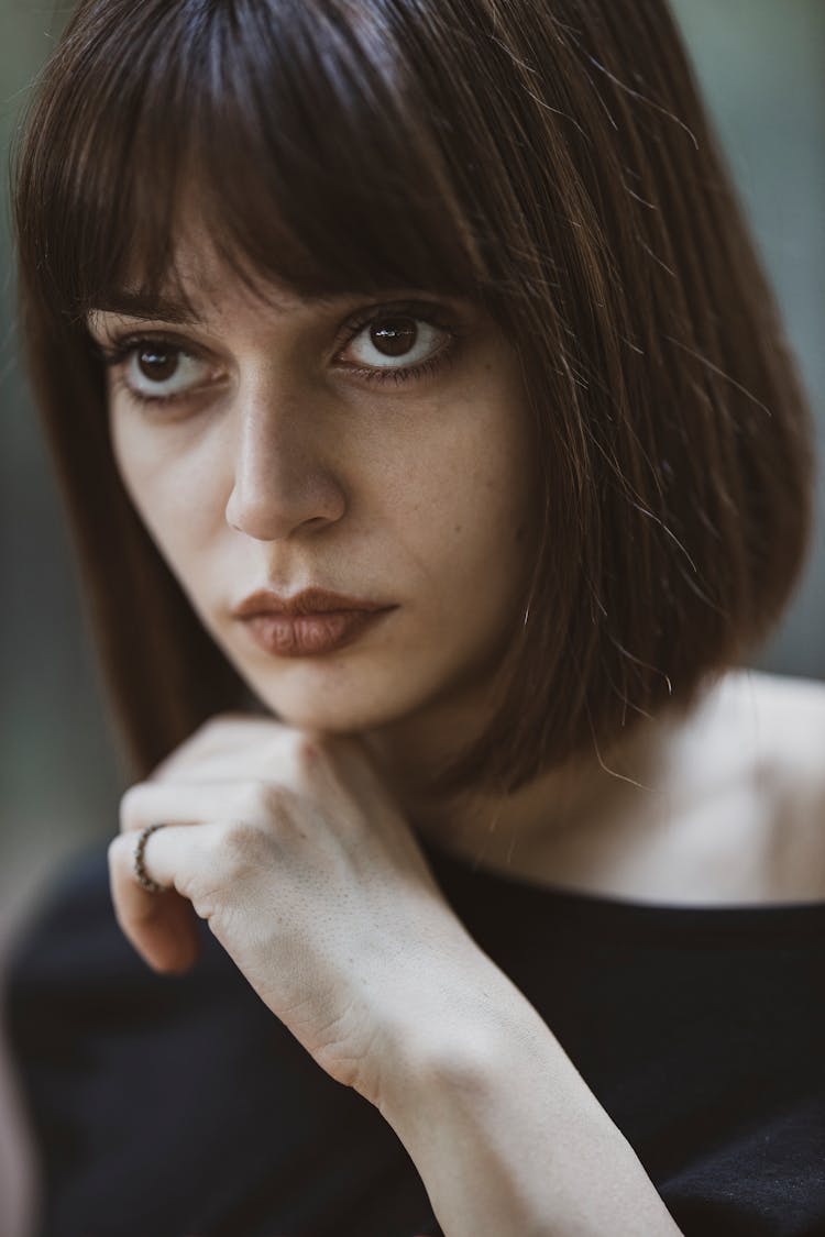 Woman Looking Up With Hand On Chin