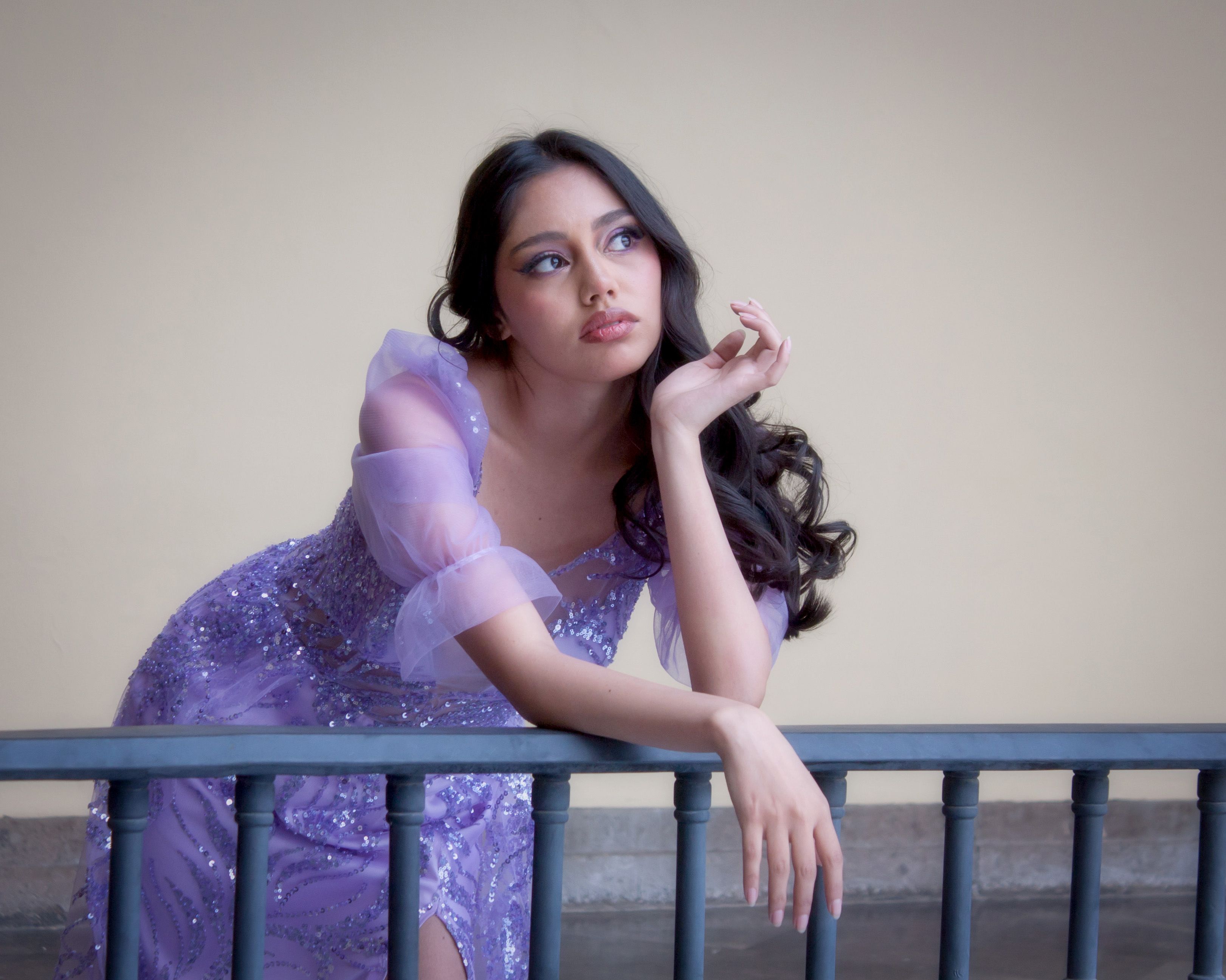 Elegant Woman in Lavender Dress Leaning on Railing · Free Stock Photo