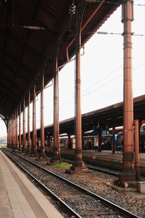 Free Historic train station with vintage columns and tracks in Europe. Stock Photo