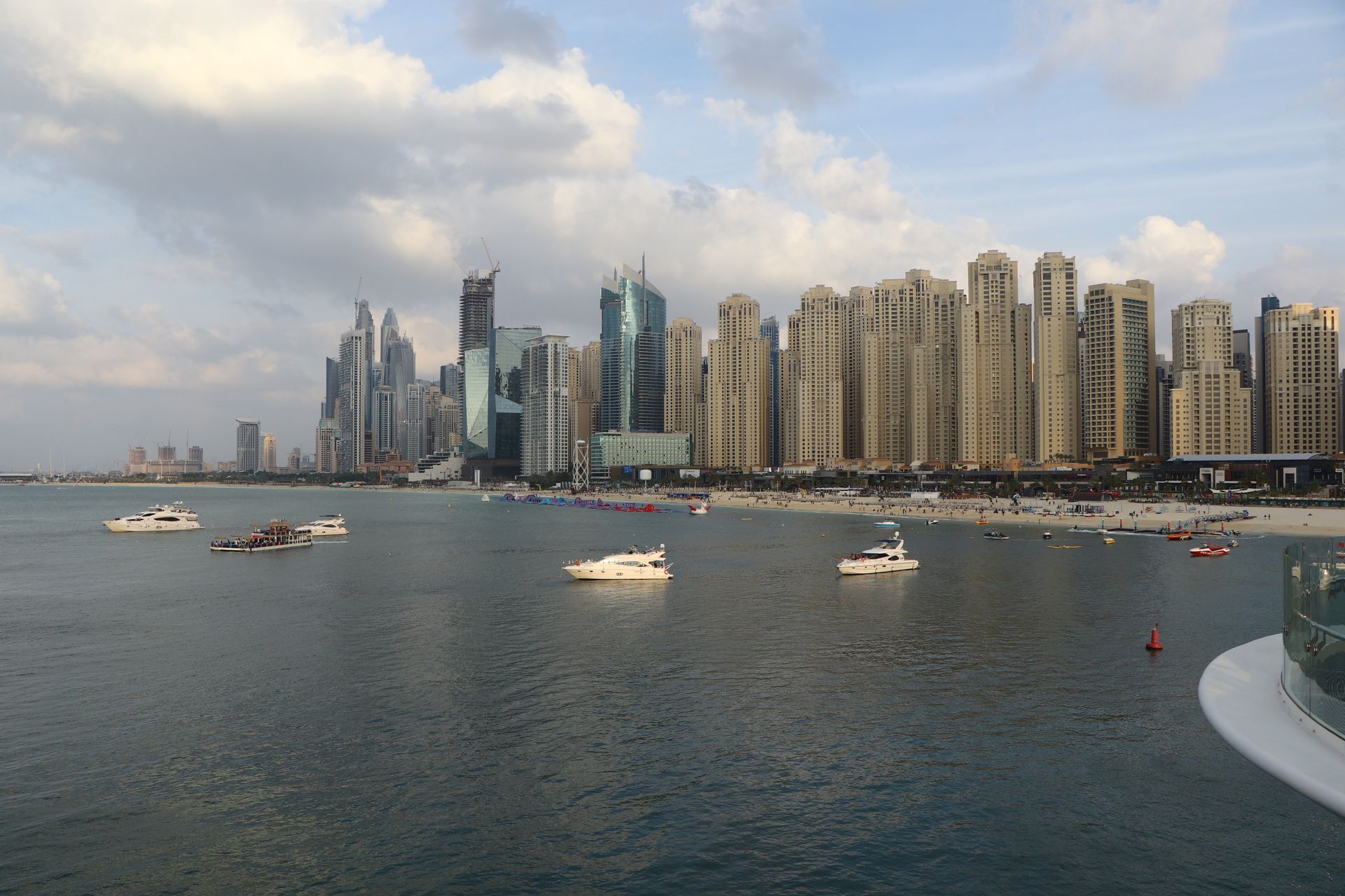 Explore the breathtaking skyline of Dubai Marina with luxury yachts in the foreground, capturing the