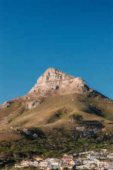 Lion's Head Mountain overlooking Cape Town's scenic landscape with clear sky.