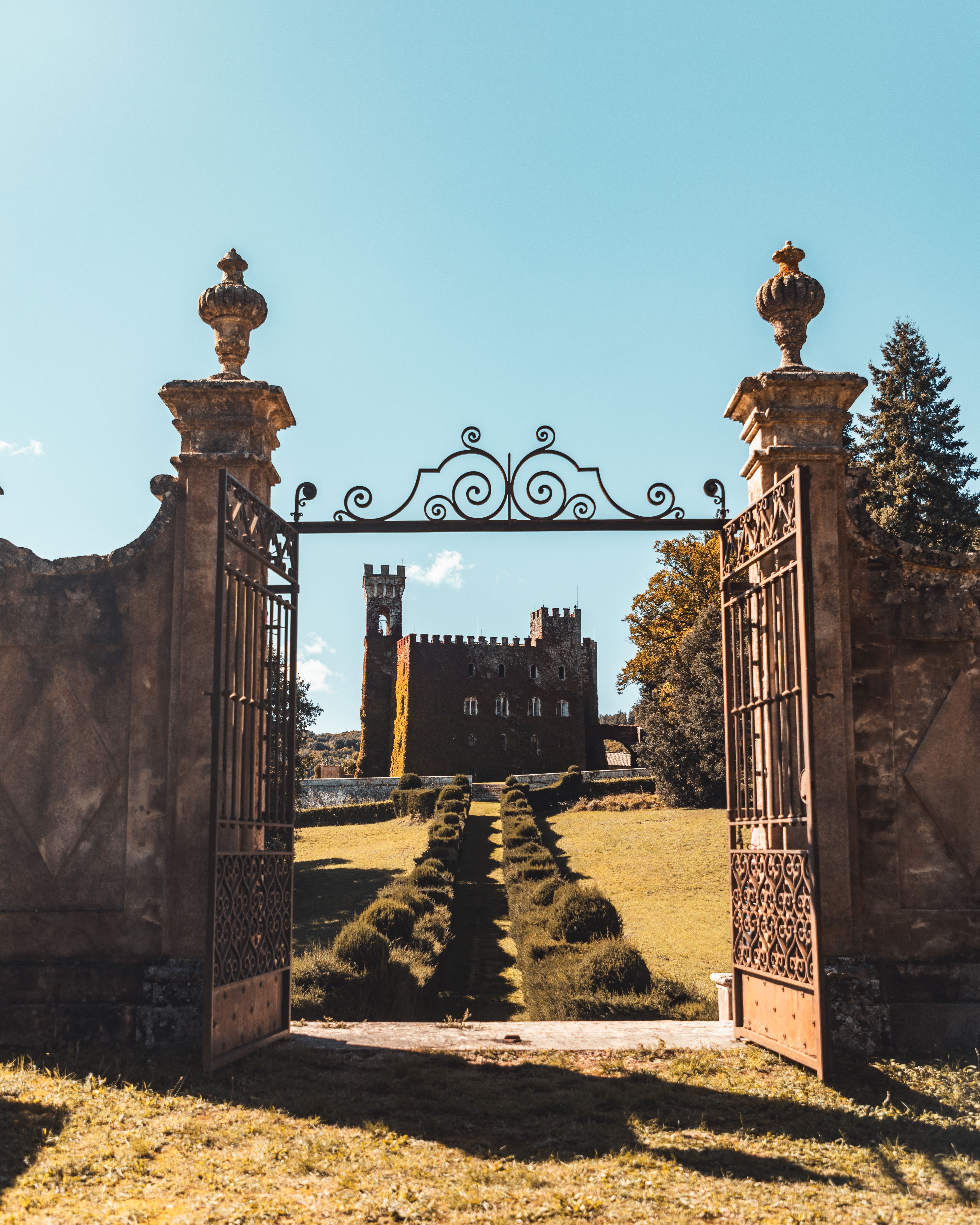 Majestic Castle Through Ornate Iron Gate · Free Stock Photo