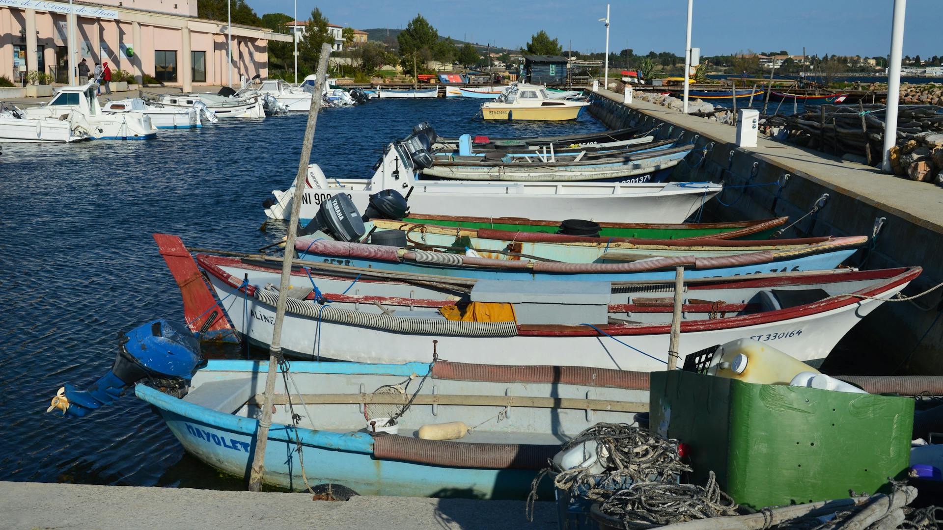 Charming scene of colorful fishing boats moored in Bouzigues, Occitanie, France.