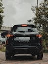 Black SUV Parked Outdoors Under Cloudy Sky