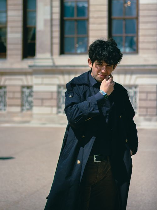 Free Stylish man in trench coat poses confidently outside a historical building in Istanbul. Stock Photo