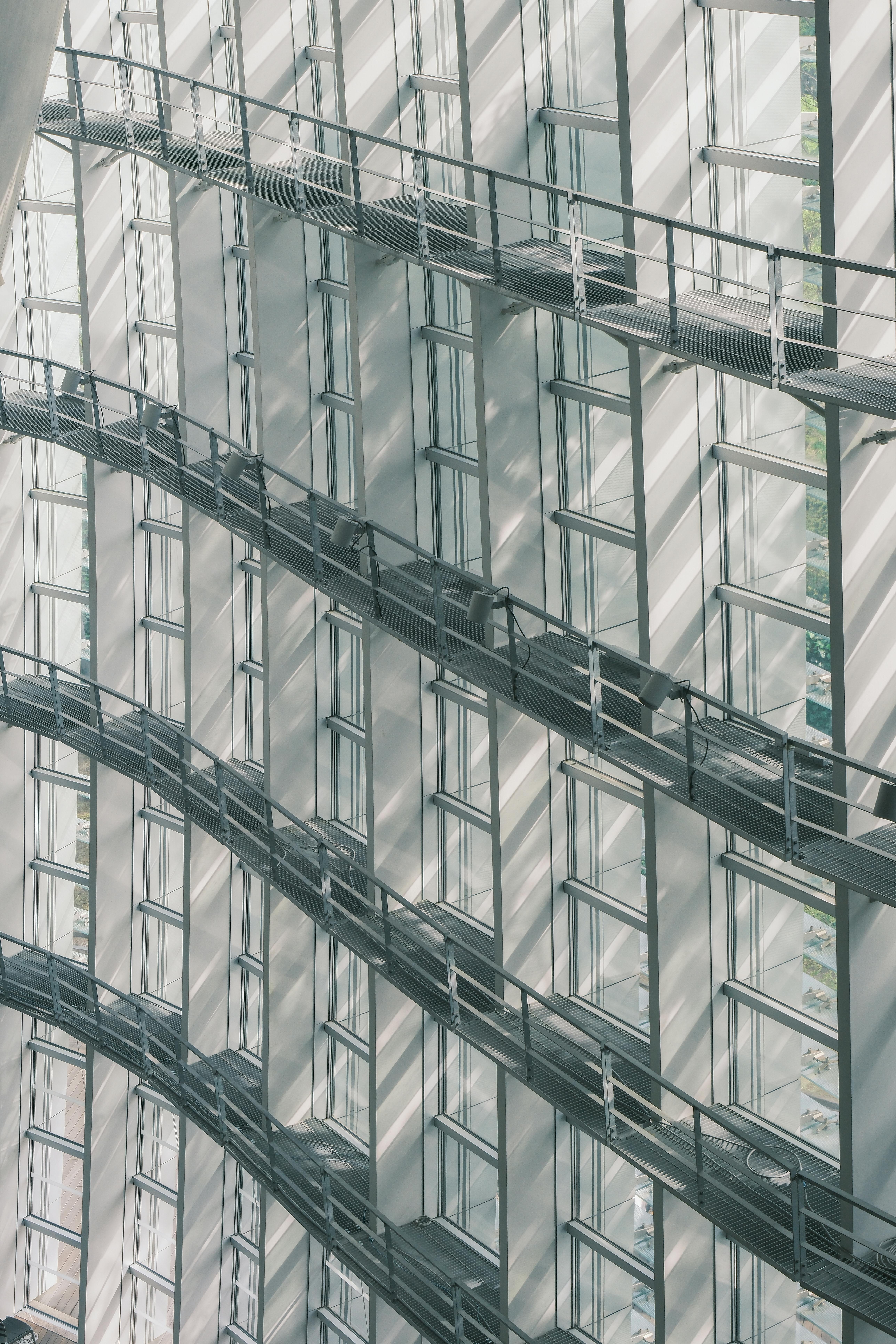 A sleek modern architectural staircase in a sunlit interior of Tokyo, Japan.
