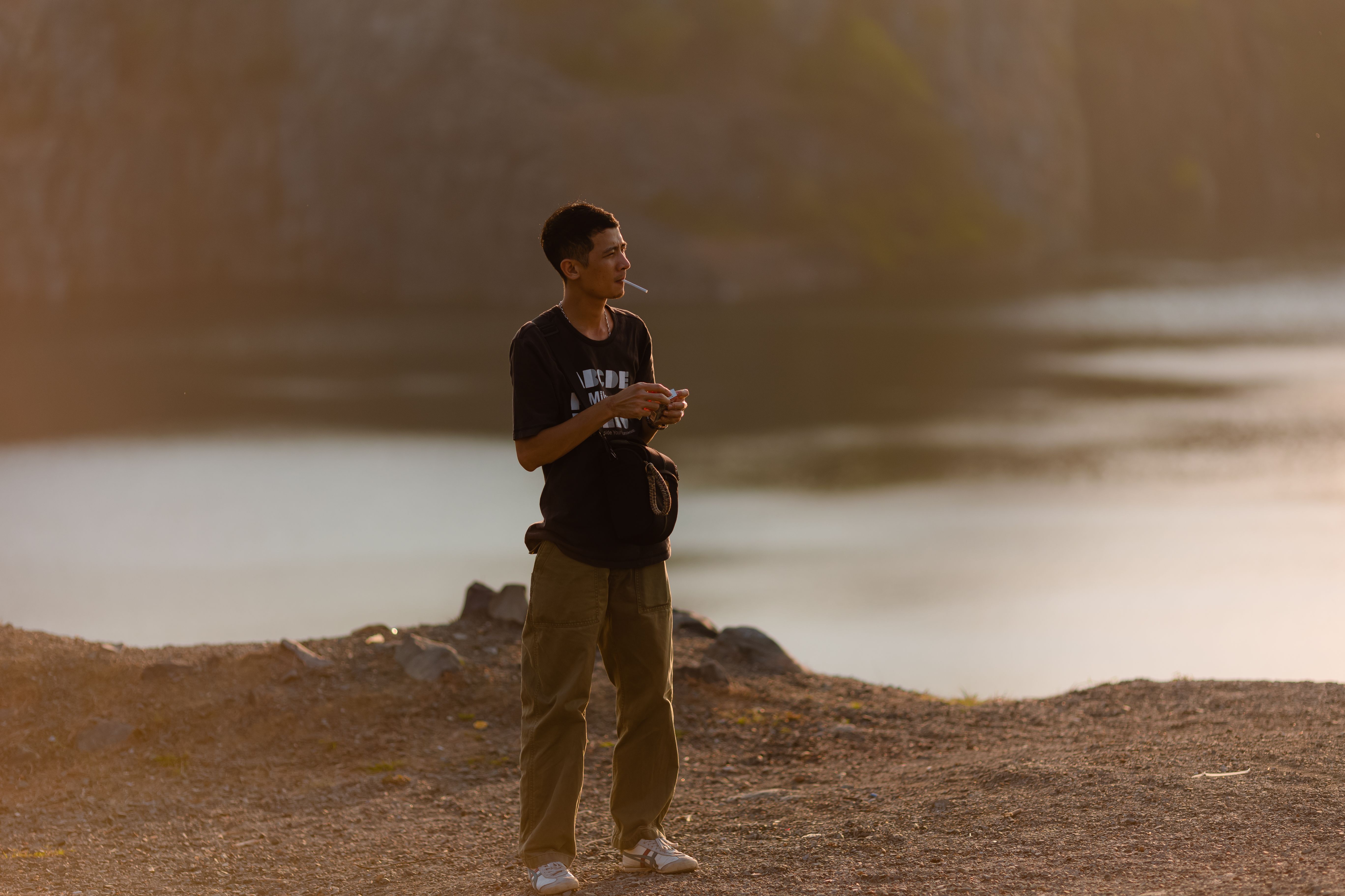 Contemplative Man by the Lakeside at Sunset · Free Stock Photo