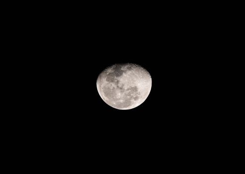 A detailed photograph capturing the moon against a dark night sky in Thailand.