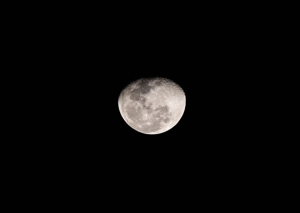 a detailed photograph capturing the moon against a dark night sky in t